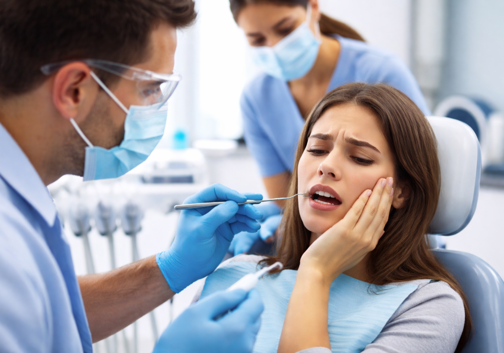 Emergency dentist in Oakville treating patient with severe tooth pain in modern dental clinic